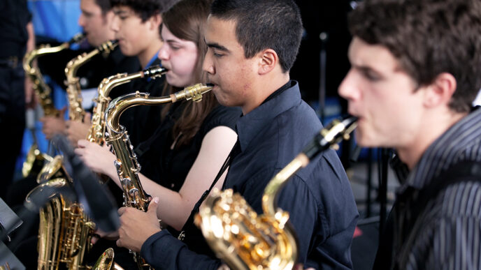 A group of high school students playing saxophones.