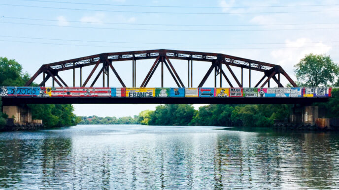 A brightly painted bridge over a river.